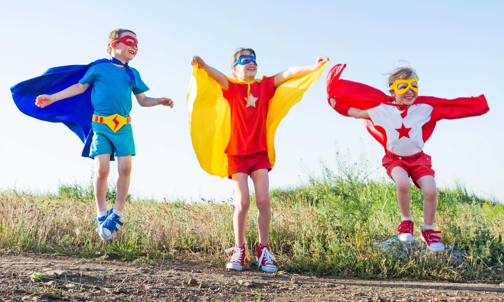 Children dressed as superheroes jumping